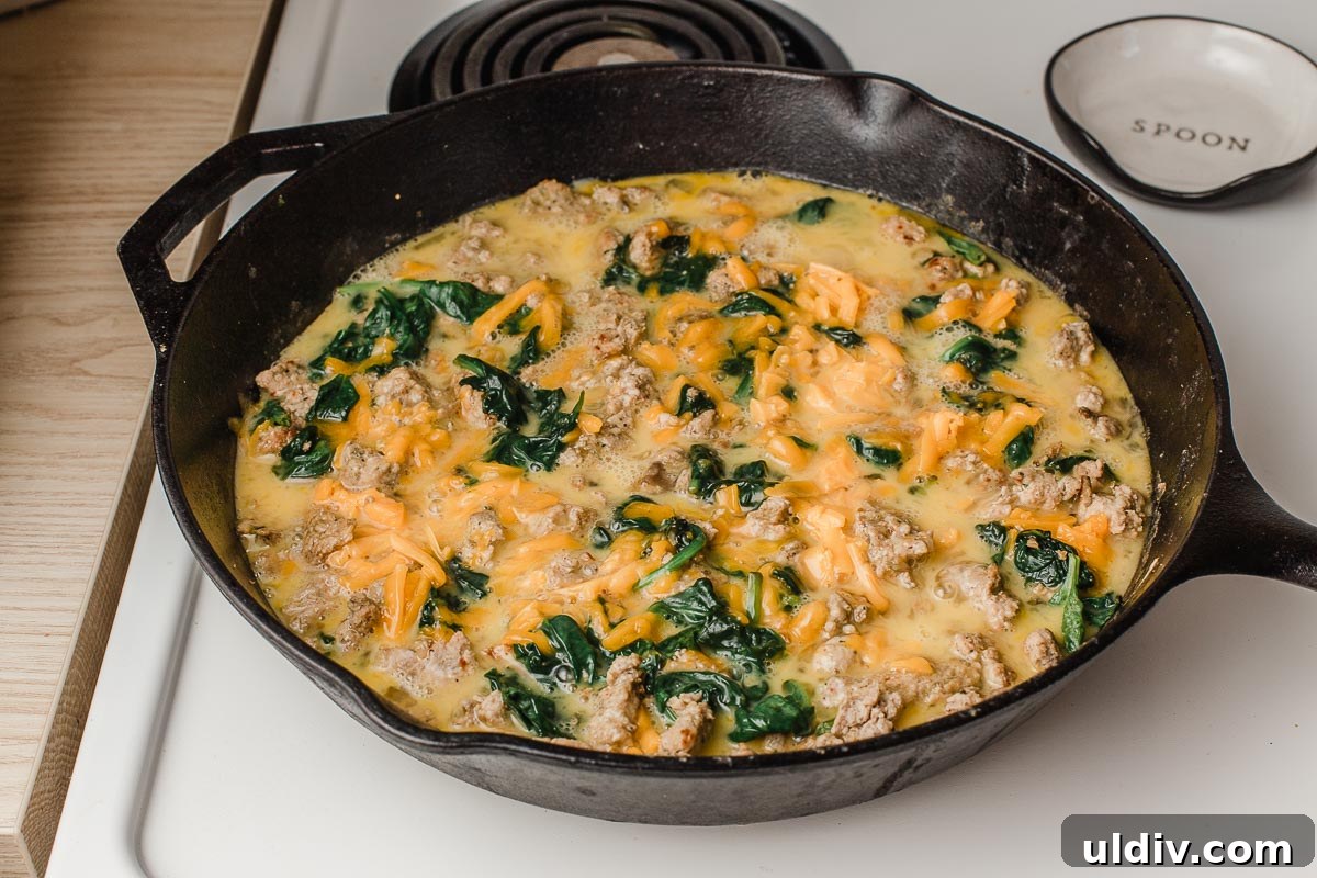 Turkey Sausage and Spinach Frittata Recipe for Weeknight Breakfast 5 Eggs poured into the skillet.