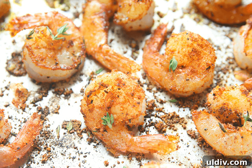 Blackened Shrimp with Cheesy Ravioli Pasta Recipe 3 Shrimp in a pan with blackened seasonings.