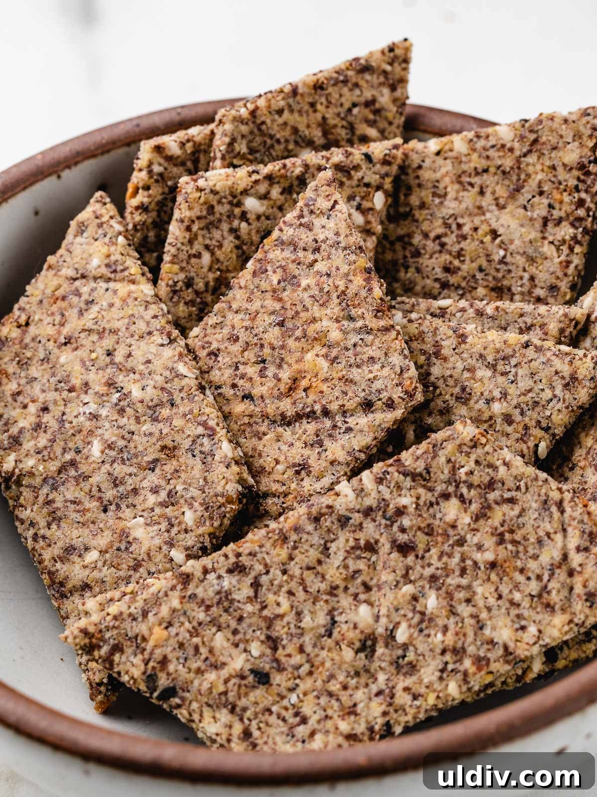 Crunch-Free Grain-Free Crackers: Crispy Keto Snack Recipe 2 Grain free crackers in a bowl.