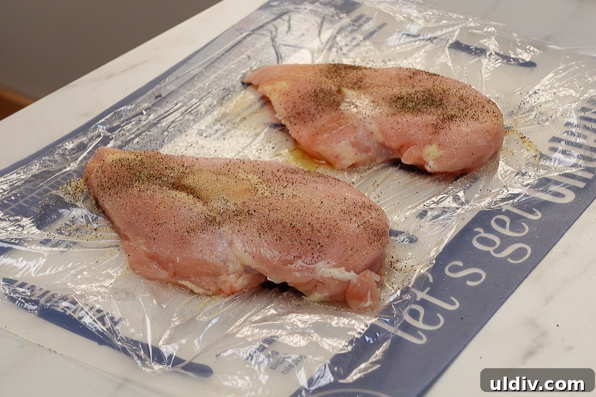 Juicy Oven-Baked Chicken Breasts with Garlic and Herbs 4 Two chicken breasts with seasoning.