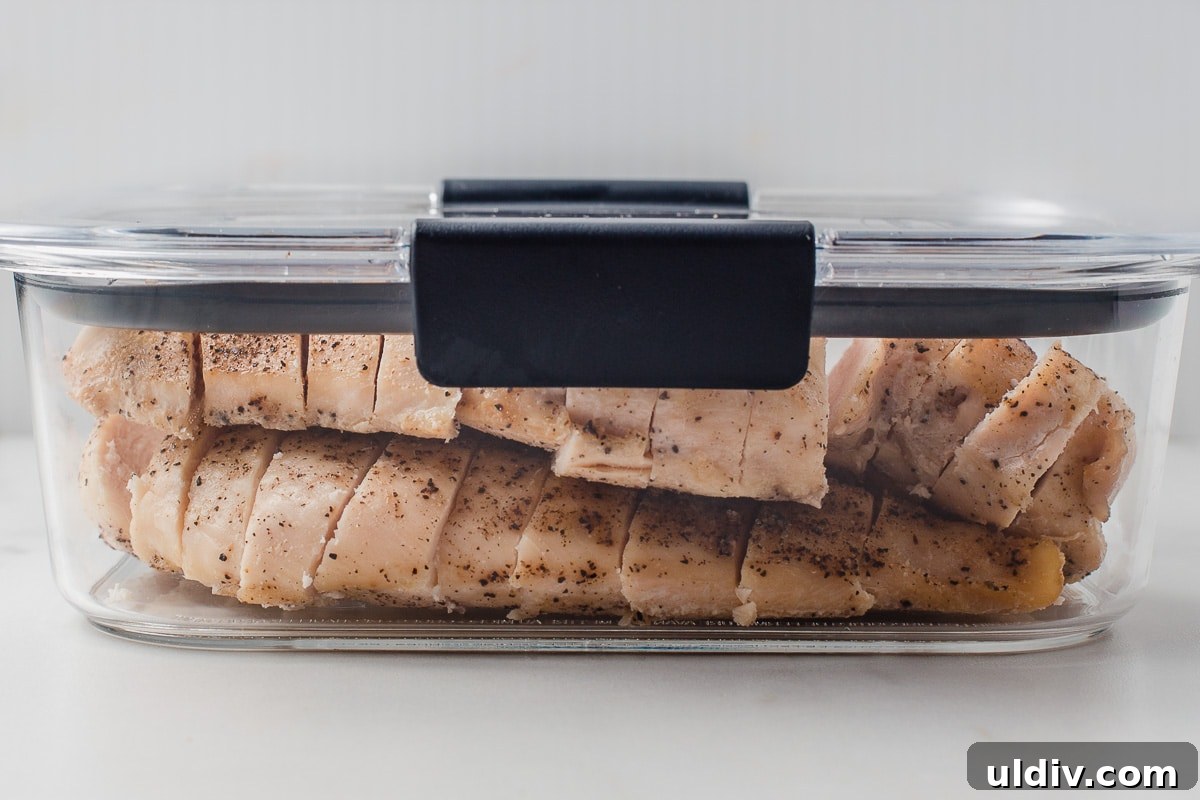 Juicy Oven-Baked Chicken Breasts with Garlic and Herbs 7 Baked chicken breast in a meal prep container.