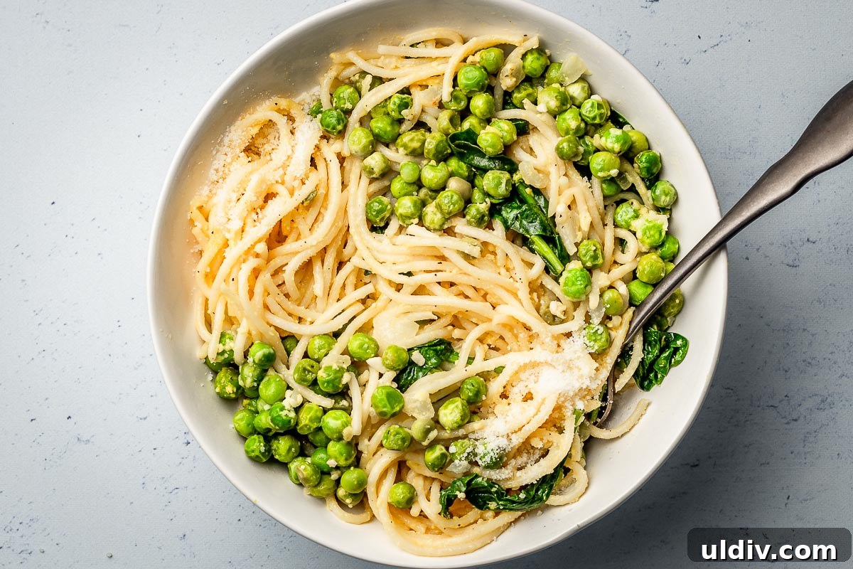 Creamy Parmesan Pasta with Sweet Peas: Quick Weeknight Recipe 3 Pasta with peas parmesan and spinach in a bowl.