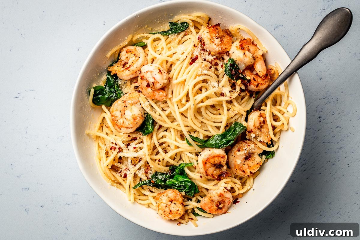 Garlic Butter Shrimp Pasta Recipe with Lemon and Parsley 3 Pasta with garlic butter shrimp bowl with spoon.