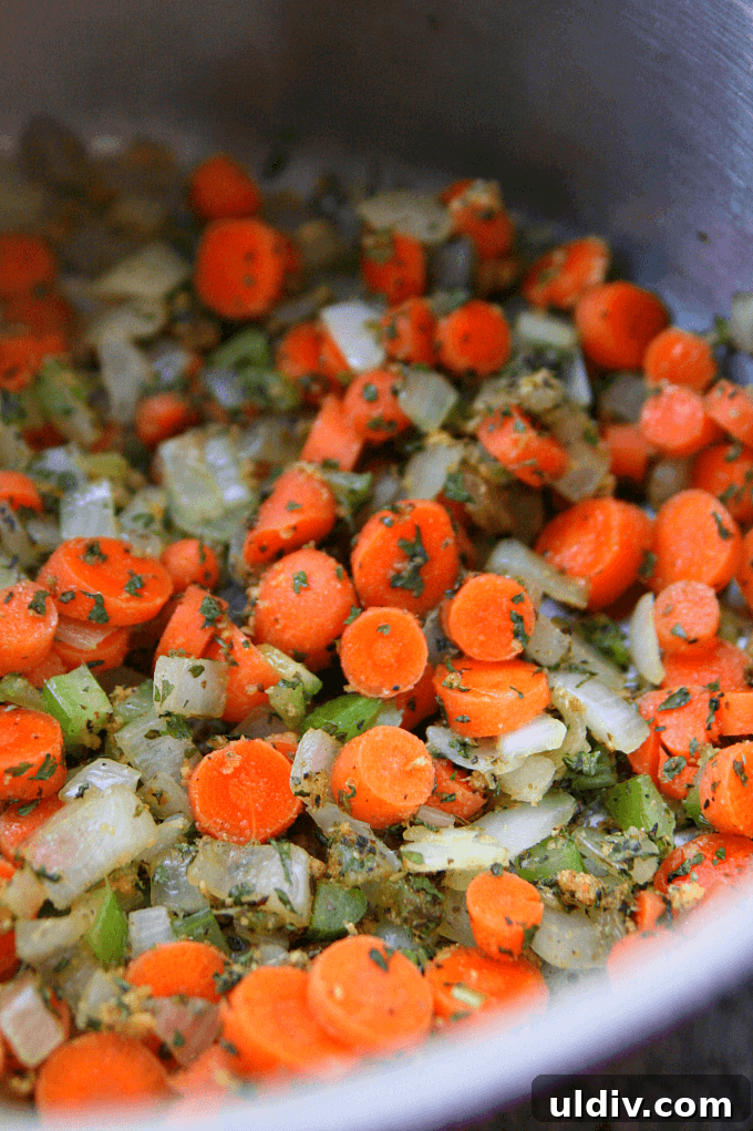 Hearty Homemade Lentil Soup Recipe for Comforting Weeknight Meals 3 Vegetables being sautéed in a saucepan.