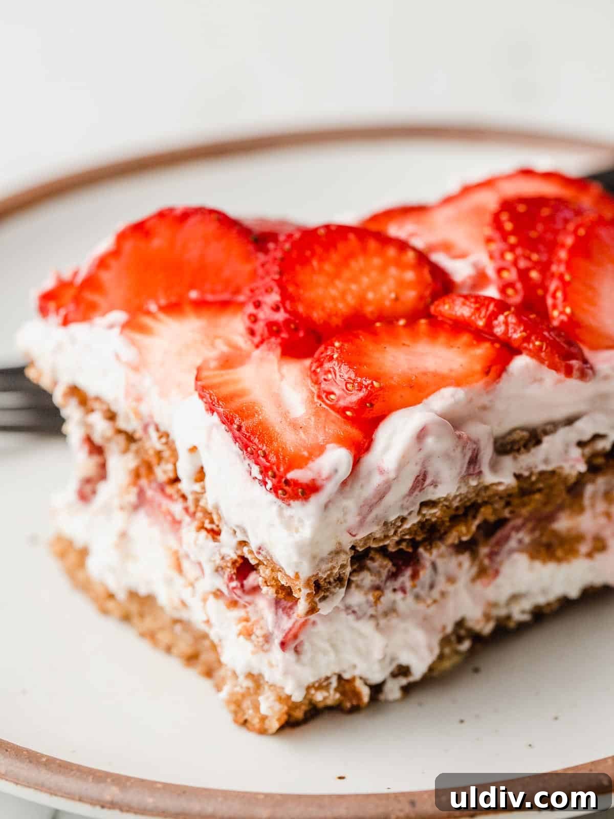 A slice of gluten-free strawberry icebox cake on a plate.
