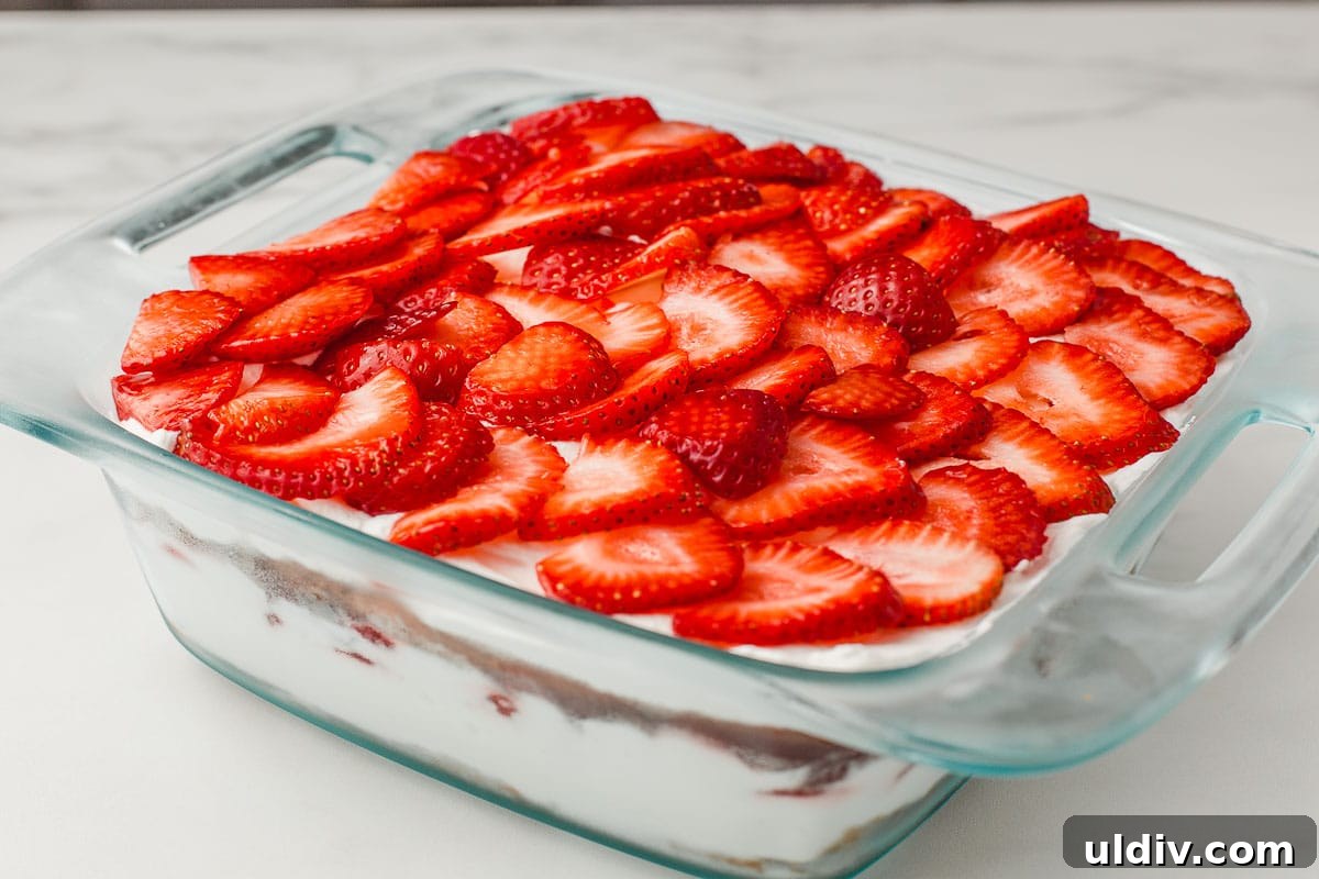 A baking dish with the finished gluten free strawberry icebox cake.