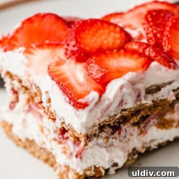 A closeup photo of a slice of gluten-free strawberry icebox cake.