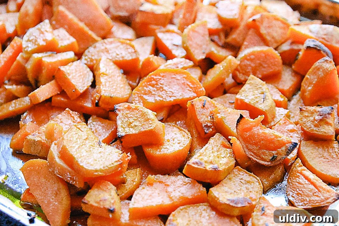 Creamy Sweet Potato Casserole with Crunchy Pecan Topping 3 Roasted sweet potatoes on a baking sheet.