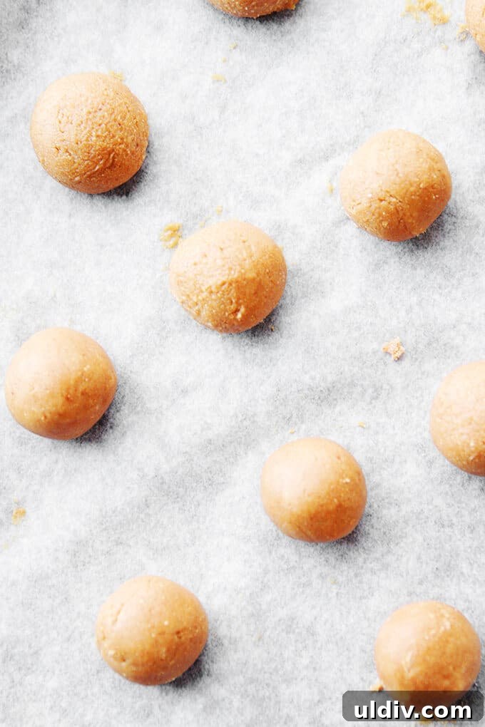 Low-Fat Peanut Butter Balls dough Dough balls on a baking sheet.