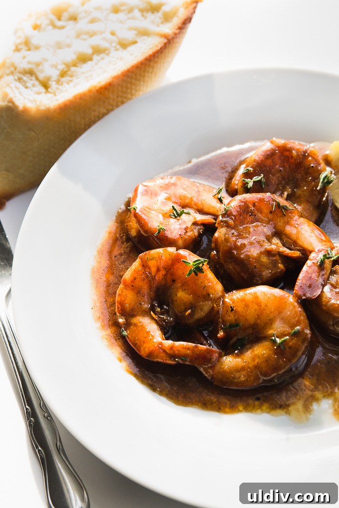 Juicy succulent shrimp in a buttery lemon Worcestershire sauce. Plate of New Orleans BBQ Shrimp