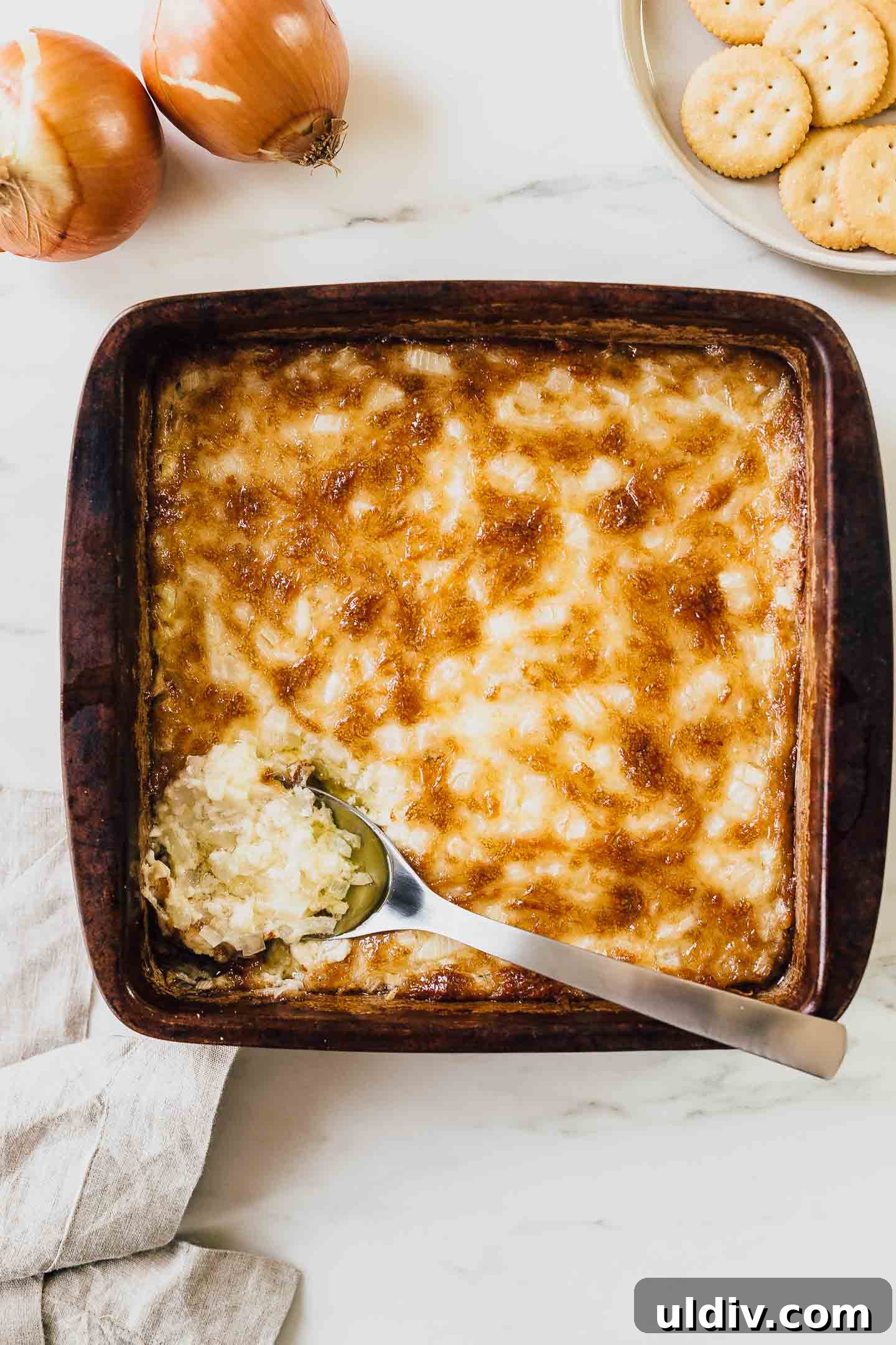 Hot onion dip in baking dish.