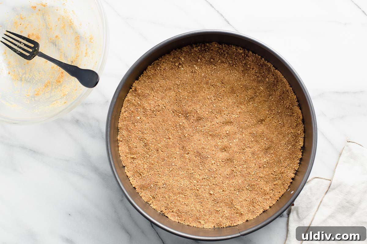 Classic Creamy Cheesecake Recipe for Perfect Results 3 A graham cracker crust pressed into a spring-form pan.